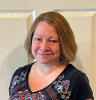 A photo of Mrs. Flail in front of a white door